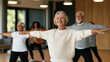 © Kateryna Arkhypova - Diverse group of older adults participating in a friendly low-impact fitness class indoors, gentle stretching and mobility exercises, arthritis-friendly workout, joint health,