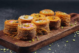 Middle Eastern Kataifi desserts arranged on a wooden board