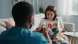 © Sawera - Professional male doctor applying medical tape to the arm of a young female patient receiving treatment at her home residence
