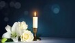 © Jeanny - Funeral Condolence Candle and White Floral Arrangement on Moody Blue Background