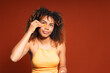 © Gonzalo Infiesta - Young black woman applying under eye patch for skincare