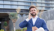 © G.S.Rob - A businessman smiles as he receives a phone call with good news