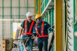 © SpaceOak - Industrial worker wearing hard hat and safety vest inspecting machinery and equipment at work site
