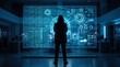 © Jessica - Mysterious hooded hacker silhouette standing before large futuristic transparent screen displaying binary code and data interface, representing cybersecurity threat, digital crime