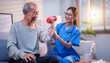 © Aryanto - Professional nurse guiding elderly Asian man lifting dumbbell at home for geriatric rehabilitation physical therapy and active strength recovery process