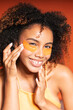 © Gonzalo Infiesta - Smiling woman applying orange under eye patches