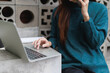 © MINAE - Woman multitasking, managing her time efficiently while communicating on a smartphone and working remotely on a laptop in a modern environment
