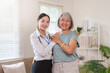 © Natee Meepian - Asian doctor and senior patient smiling together during home healthcare visit