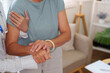 © Natee Meepian - Cropped hands of doctor supporting senior patient for healthcare reassurance