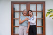 © Natee Meepian - Smiling Asian nurse hugging happy senior woman outdoors for home healthcare service