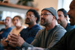 © Milos - A diverse group of professionals engaged in a lively discussion at a modern workspace, showcasing collaboration and teamwork in a friendly environment.