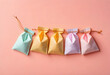 © Pixel-Shot - Gift bags and party favors, colorful paper pouches for celebration and special occasions, festive decoration on pink background
