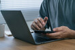 © PlengPleng - Man using smartphone and laptop for online banking, two factor authentication, digital payment, and remote work