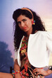 © AresStudio Belen y Carlos/Stocksy - Woman posing wearing bold 80s fashion and colorful accessories