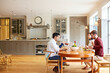 © peopleimages.com - Talking, home and friends in conversation for lunch, dinner and social gathering on weekend. Happy, holiday and people with food, drinks and chatting for bonding, connection and reunion for visit