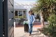 © elbuenodehal - Woman pulling recycling bin out of house