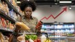© Kristina - Concerned Black woman compares grocery products in a supermarket as rising food prices and inflation increase household living expenses.