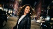 © Zahra - Smiling young woman in leather jacket showcasing curly hair, night city street and cheerful expression, concept for urban lifestyle and nighttime adventure