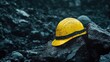© Nur Hanisah - Yellow hard hat rests on a pile of coal