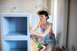 © Marko Geber - Young woman cleaning kitchen cabinet at home