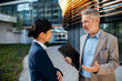 © Davor - Business professionals discussing project outside office