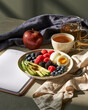 © Benjaporn - Elegant breakfast table with avocado berries boiled egg and herbal tea highlighting metabolic flexibility and morning wellness ritual
