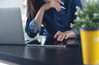 © tippapatt - Close up, business woman using stylus pen and digital tablet working at office with laptop on desk.