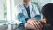 © tippapatt - Female pediatrist doctor reassuring her young boy patient at medical clinic, closeup