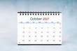 © gamjai - October 2027 Monthly desk calendar on vintage wall, Front view.