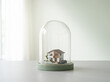 © Night - Miniature house model inside glass dome on wooden table, real estate concept