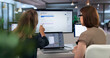 © Andrey Popov - Two Women Collaborate On AI Platform Using Laptops