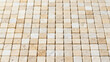 © Евгения Жигалкина - Tumbled beige and white natural stone mosaic tile sheet featuring travertine or marble square chips arranged in a neat grid, creating a warm, elegant, textured surface for interior design.