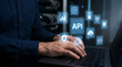 © MdAmin - Programmer working on laptop with API software interface development in data center