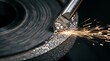 © Putra - Diamond cutting wheel sharpens metal tool, creating sparks. Close-up.
