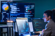 © ultramansk - Brazilian IT security analyst reviewing malicious code patterns and firewall activity logs to prevent unauthorized access in a corporate network.