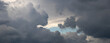 © Larysa - Massive storm clouds with glimpse of blue sky between them