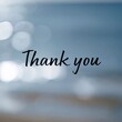 © JPminimal - Close up view of a handwritten thank you message in ink on a glass surface with a soft blurred background