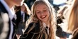 © Anastasiya - A joyful young girl in a school uniform laughs brightly outdoors, surrounded by classmates in a sunny, cheerful school setting.