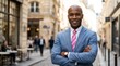 © PhanDesigns - A confident black businessman wearing a professional suit in a city street setting.