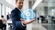 © MHS-AI - Confident business professional in suit holding glowing cloud computing interface with gear icon in modern office with blurred colleagues working in background and bright sunlight