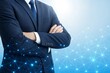 © Dekap - Confident business executive in blue suit with arms crossed over digital network background