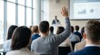 © Ruby - Hands raised by audience members during a professional seminar or conference discussion.