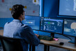 © SAT65 - Machine learning engineer reviewing AI model dashboard and system performance at computer workstation while analyzing technical metrics, software status, data visualization and model results.