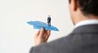 © Pukan - Businessman holding a blue paper airplane carrying a miniature executive figure, startup career concept.