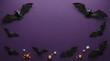 © MarufIslam - Halloween background with decorative black bats arranged around a purple copy space for text