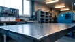 © Abode stock - Clean metal workbench surface in workshop environment with tools organized on wall and machinery in background showing professional workspace for skilled craftspeople and industrial tasks.