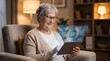 © jahid - Senior woman monitors health data on holographic tablet screen at home to demonstrate active aging and digital wellness tracking for modern elderly lifestyles.