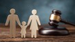 © Zarana  - Wooden family figures standing next to a judge gavel on a desk for family law and legal custody concepts.