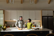 © Wavebreak Media - Diverse couple with senior man preparing food at modern kitchen island with bread basket