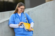 © Pixel-Shot - Medical education and healthcare career, young female doctor or student in scrubs with stethoscope and notebooks